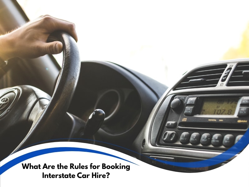 Interstate Car Hire driver hand on steering wheel with dashboard controls in a moving car interior