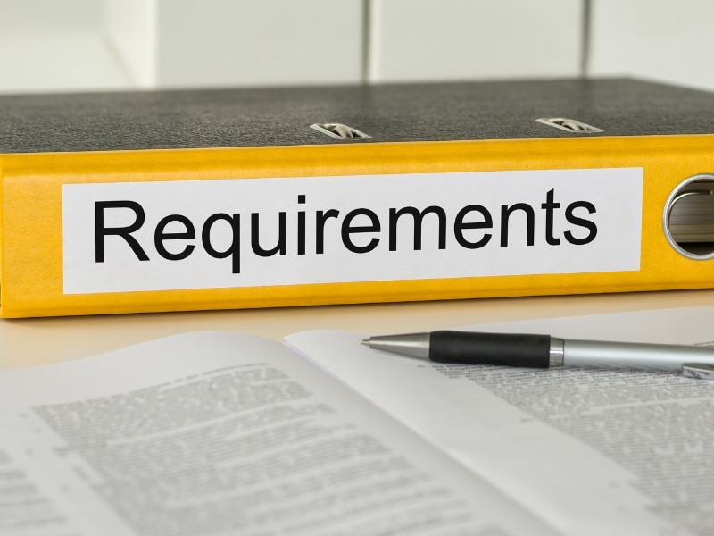 Interstate Car Hire requirements binder with pen and open policy documents on a desk